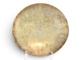 a large drum on a stand on a white surface