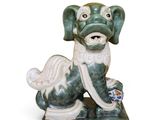 a figurine of a dog that is sitting on the ground
