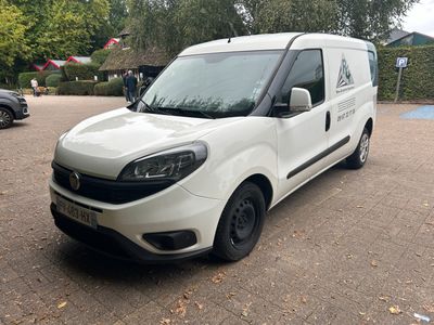 the white van is parked on the side of the road