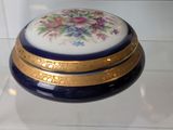 a blue and gold box with a floral design on it