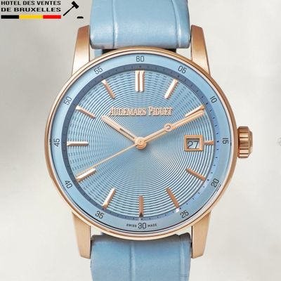 a close up of a wrist watch with a blue dial