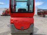 an image of a small red vehicle parked in a parking lot