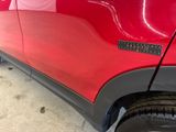 a close up of a red car with a sticker on it