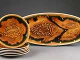 several plates with fish designs are stacked on top of each other