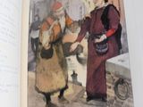 un livre ouvert sur lequel figure l'image d'un homme tendant quelque chose à une femme