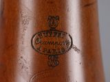 a close up of a wooden vase with a label on it