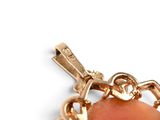 a person holding a gold chain with a heart on it