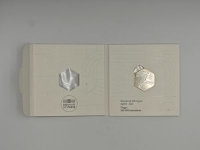 a book with a picture of a silver coin and a picture of a silver coin