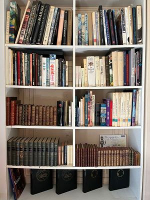 a book shelf with many books on it in a room