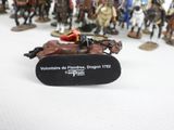 many figurines of men riding horses on a table