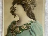 an old photo of a woman in a green dress with a flower in her hair
