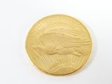 a close up of a gold coin on a white surface