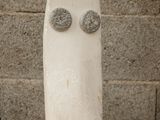 a sculpture of a face on a rock on a table