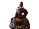 statue of a woman sitting on top of a large elephant