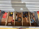 someone is holding a tool box filled with various tools