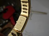 a close up of a gold wrist watch with a metal band