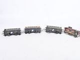 several toy trains are lined up in a row in the snow