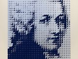 a blue and white picture of a man ' s face made out of legos