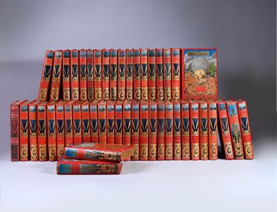 many books stacked on top of each other on a table