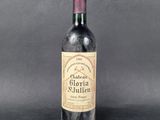 a close up of a bottle of wine on a table