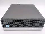 the back of a small computer with a keyboard on top of it