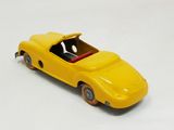 yellow toy car on white surface with white background