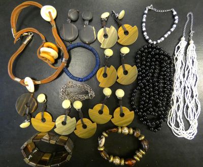 a lot of necklaces and bracelets that are on a table
