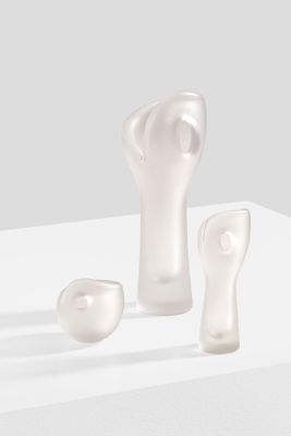 three pieces of glass sitting on a white surface