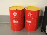 two red barrels sitting next to each other on the floor