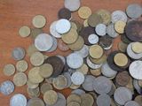 a pile of coins sitting on a wooden table