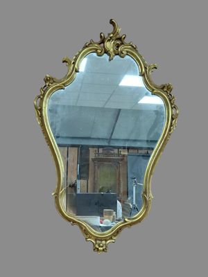 a mirror that is hanging on the wall in the room