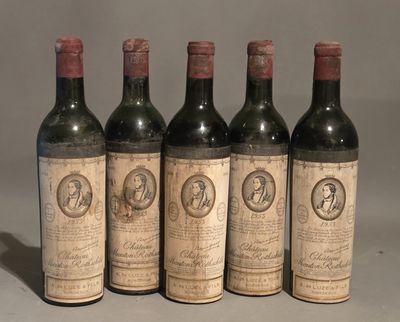 four bottles of wine are lined up on a table
