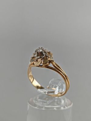 an image of a gold and diamond ring on a clear surface