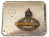 an old silver and gold belt buckle with a bird on it