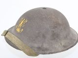 an old helmet with a gold eagle on it on a white surface