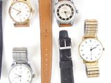 a lot of watches that are sitting together on a table