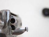 a close up view of a gun with a knife in the background