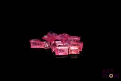 a lot of pink cubes on a black surface