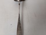 a spoon and a spoon rest on a white surface