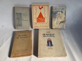 three books sitting on top of a white table next to each other