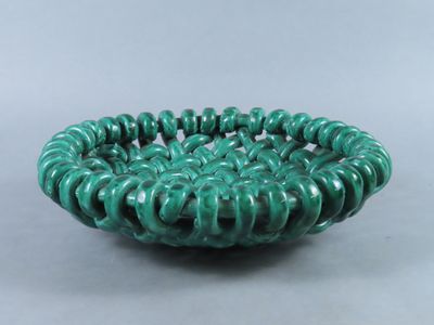 a close up of a green bowl on a table