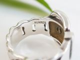 a close up of a silver ring with the word hermes on it