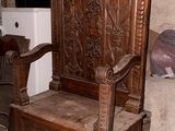 a wooden chair that is sitting in the corner of a room