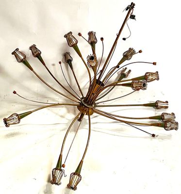 a metal sculpture of a bunch of flowers on a white surface