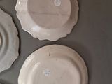 several plates are arranged on a table with a gray background