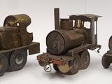 three toy trains sitting next to each other on a white surface