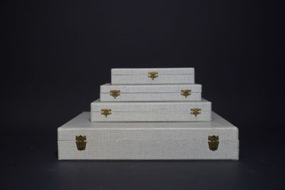 three white suitcases stacked on top of each other