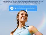the woman is smiling while listening to the radio on her phone