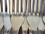a lot of forks that are sitting on a table