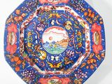 an image of a blue and red plate with a picture of a bird on it